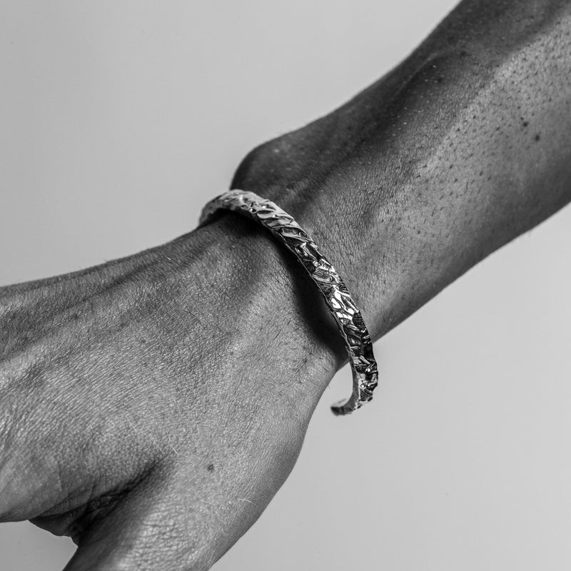 man wearing sterling silver rings and necklace