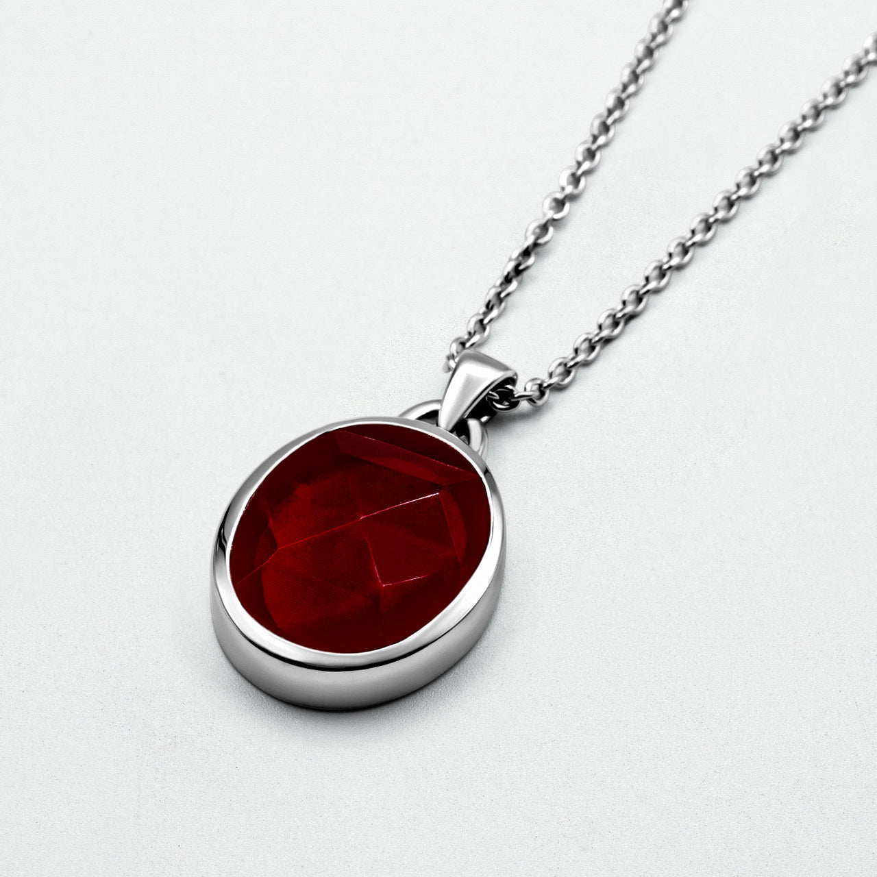 Suki Red Garnet Pendant with a rose-cut garnet set in sterling silver on a 52cm hammered chain, displayed against a clean background.