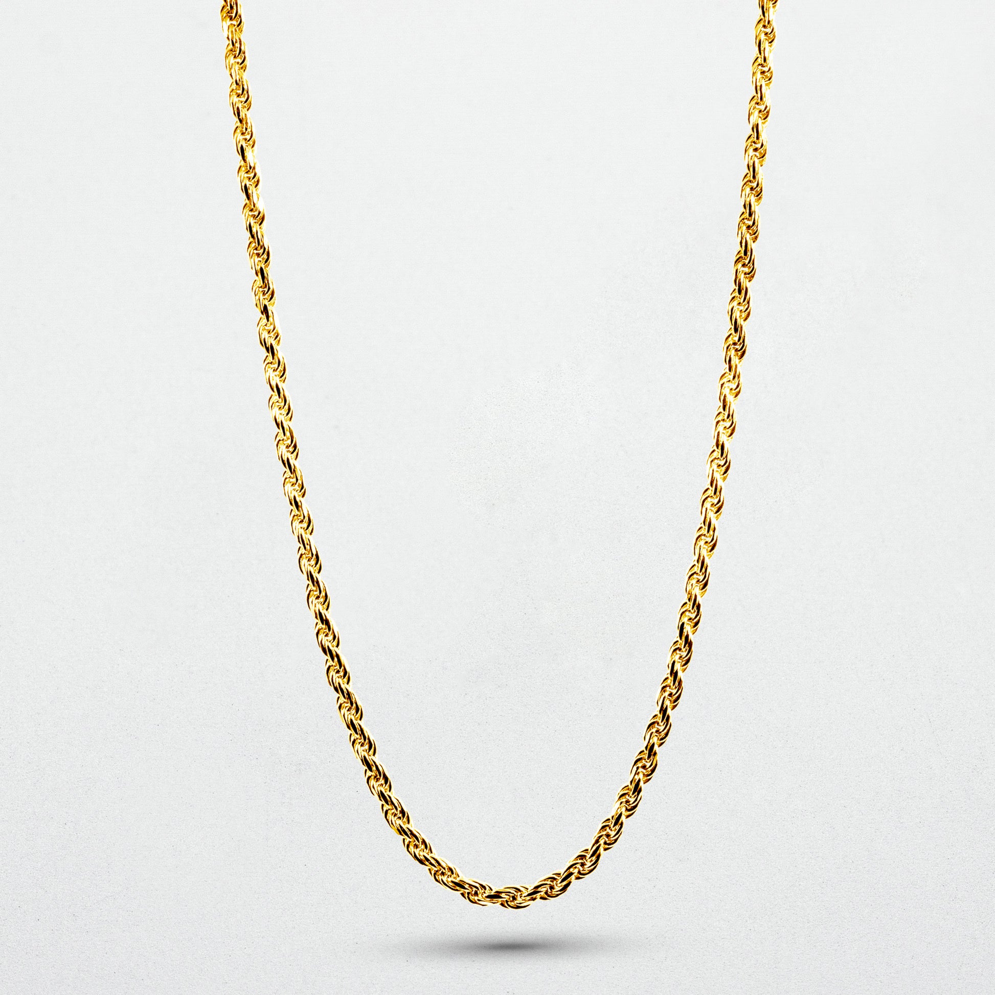 showcasing gold Iris Necklace on white canvas