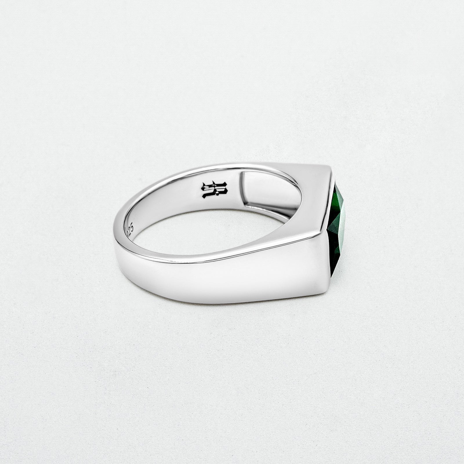 Emerald Signet Ring with a green baguette-cut glass stone set in high-polish rhodium-plated sterling silver. A bold yet minimalist design.