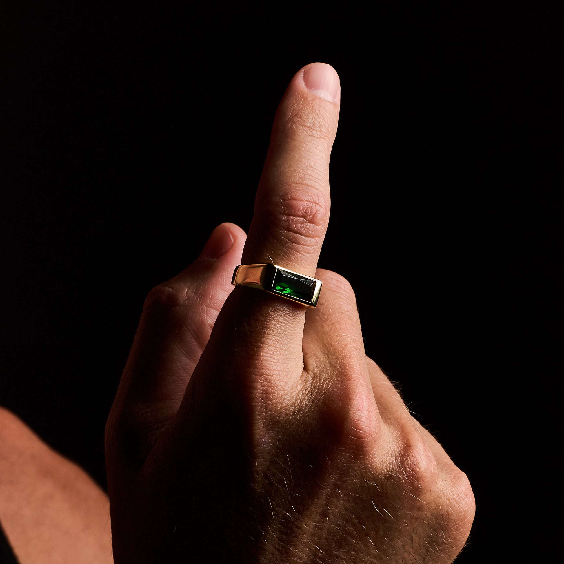 closeup shot man wearing Emerald Gold Sona Ring