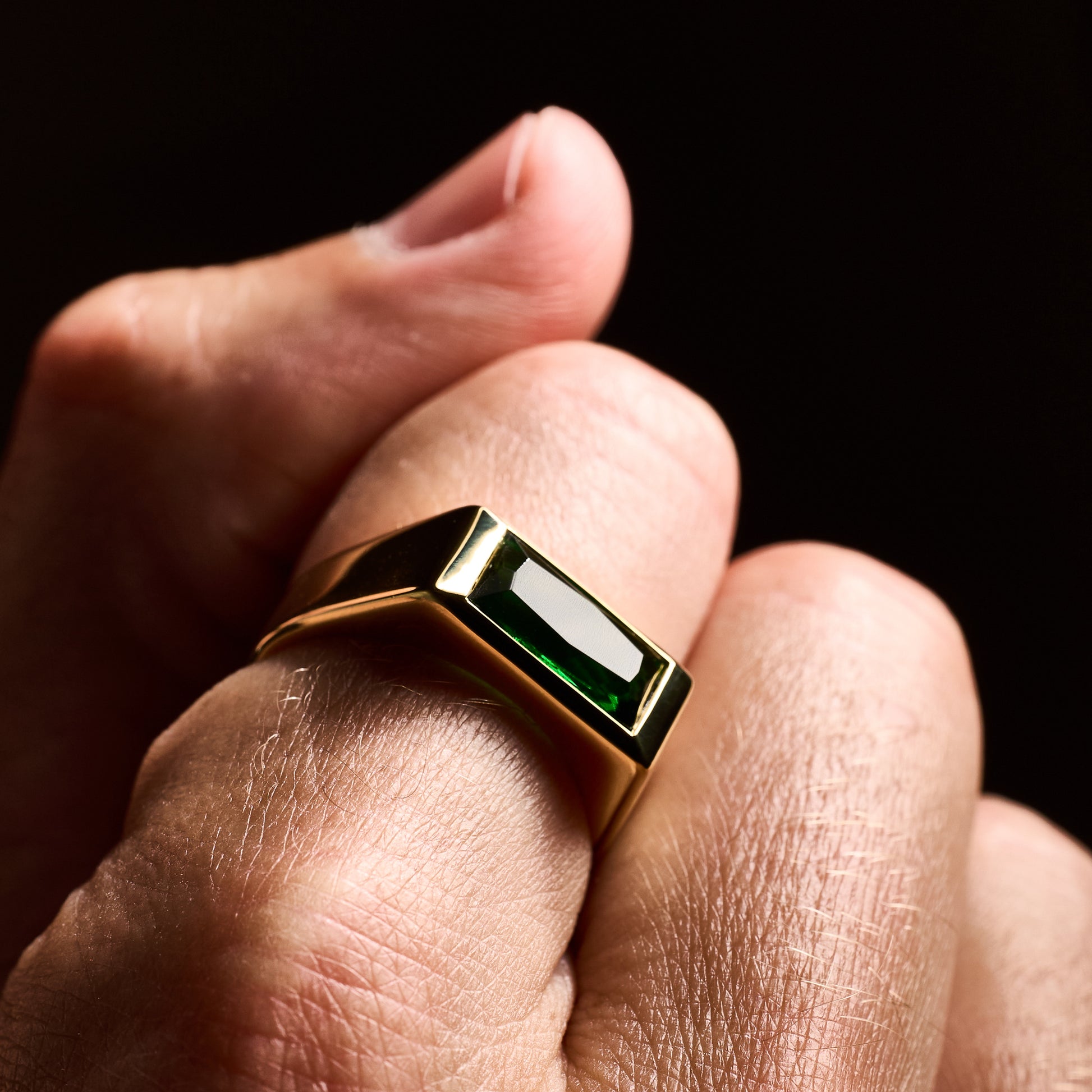 closeup shot man wearing Emerald Gold Sona Ring