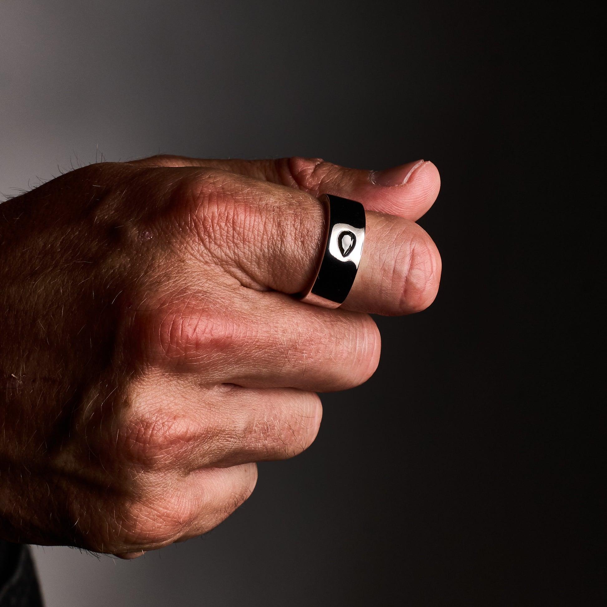 Close up of man wearing Teardrop Ring in