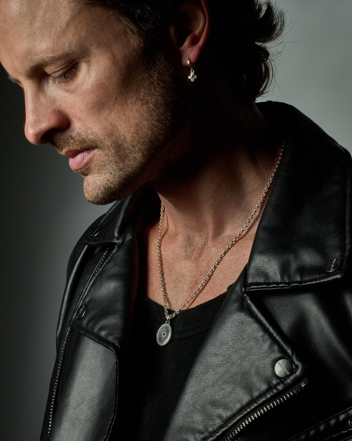 Model wearing the Sol Pendant handcrafted from solid 925 sterling silver on a sterling silver necklace one.