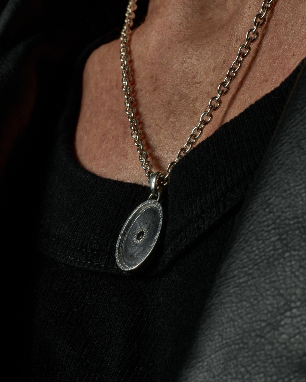 Sol Pendant handcrafted from solid 925 sterling silver featuring a central black stone.
