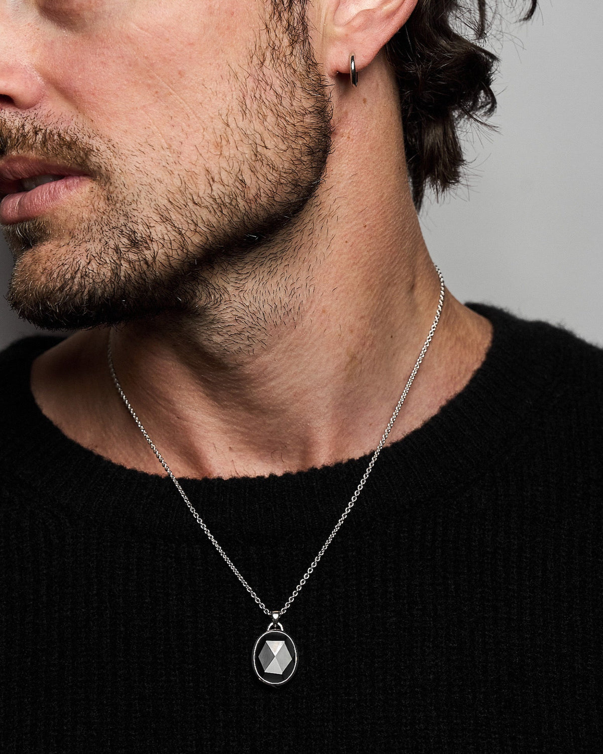 Model wearing the Suki Black Onyx Pendant handcrafted from solid 925 sterling silver on a sterling silver necklace one.